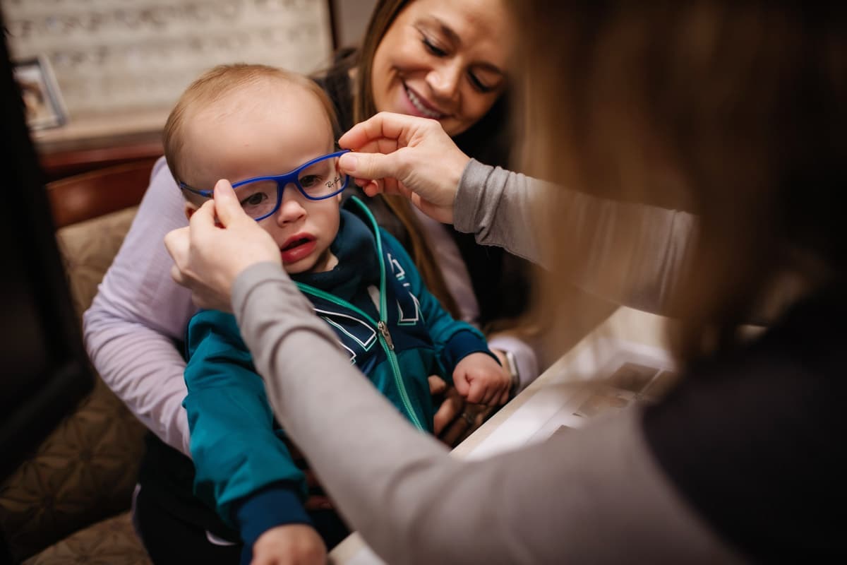 A child being fitted for eye glasses