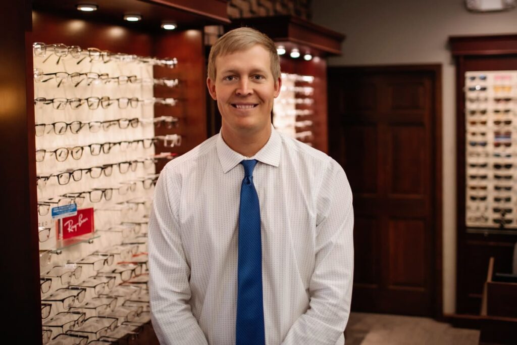 Dr. Matt Boswell standing in front of eyeglasses display