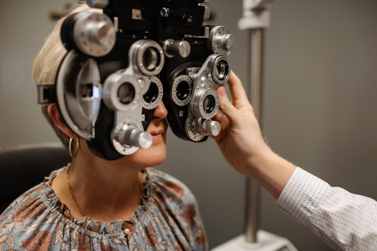 A close up of a woman taking an eye exam